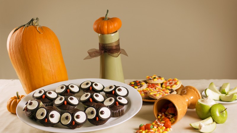 Halloween, All Hallows' Eve, All Saints' Eve, holiday table, candy, muffins, apple, pumpkin (horizontal)