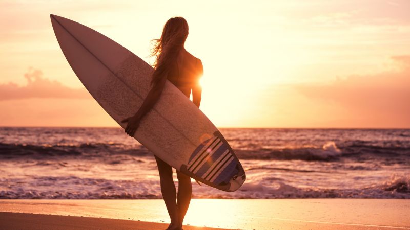 Surfing, girl, beach, sun, sea (horizontal)