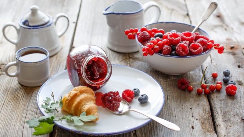 French croissants, jam, berries, raspberries, blueberries, currants, tea (horizontal)