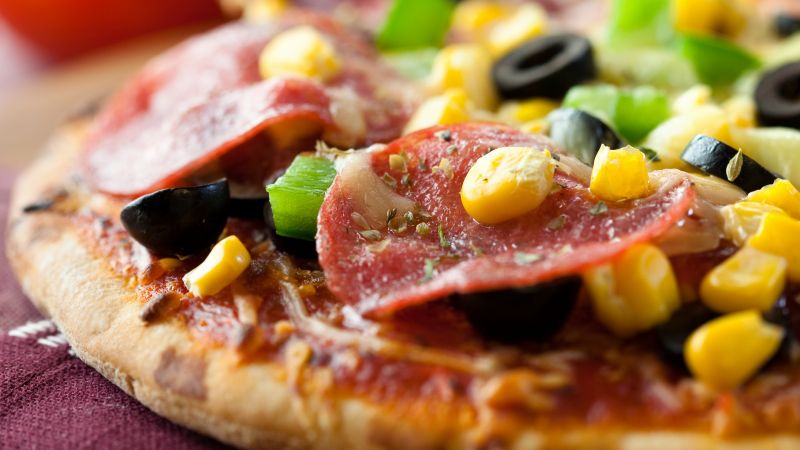 Pizza, salami, corn, olives (horizontal)