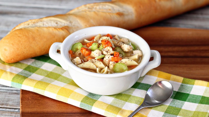 soup, chicken, noodles, carrots, peppers, onion, baguette (horizontal)