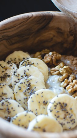 Bananas, nuts, porridge, breakfast (vertical)