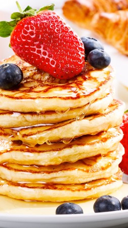 American pancakes, fruit, strawberry, blueberry, honey (vertical)