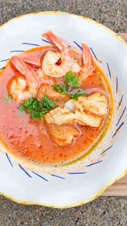 seafood soup, shrimp, tomato sauce, greens, croutons (vertical)