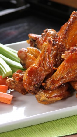 Buffalo wings, sauce, vegetables, carrots (vertical)