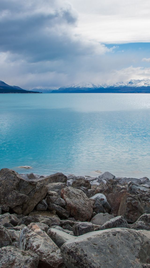 Lake Pukaki, New Zealand, stones, clouds, mountains, 4k (vertical)